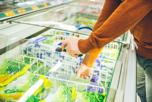 man-get-frozen-food-from-fridge-in-store